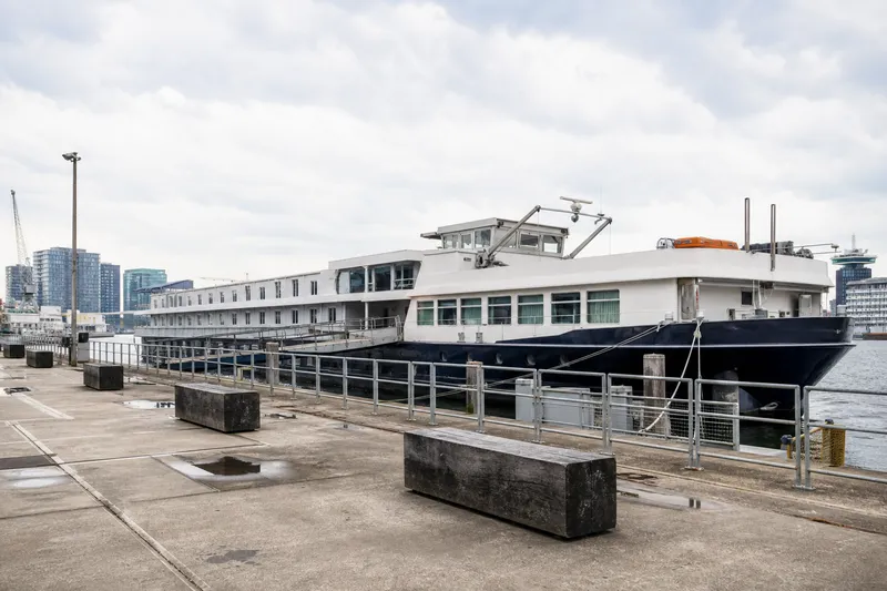 A floating hotel boat moored at Amsterdam's waterfront