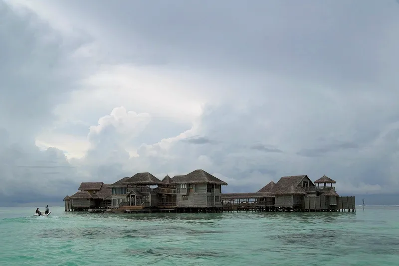 Luxury floating resort villas moored on calm turquoise water