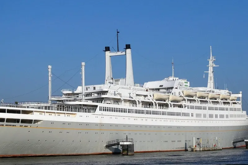Historic ocean liner converted into a floating hotel docked in Rotterdam harbor