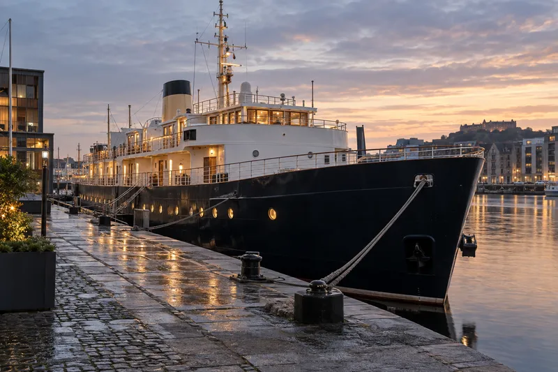 Fingal luxury floating hotel ship moored in Edinburgh harbor at sunset