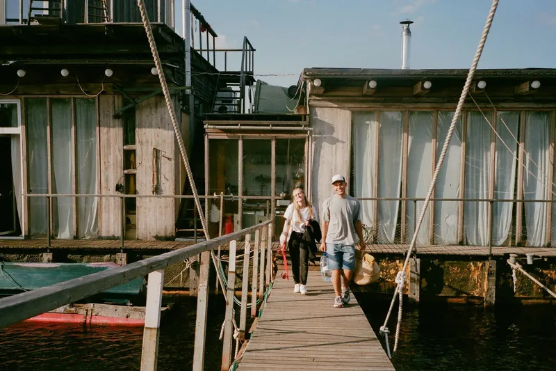 Houseboat with safety railings and a boarding gangway over the water