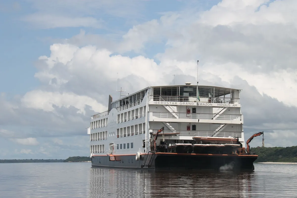 Expedition riverboat hotel cruising along a tropical rainforest river in the Amazon