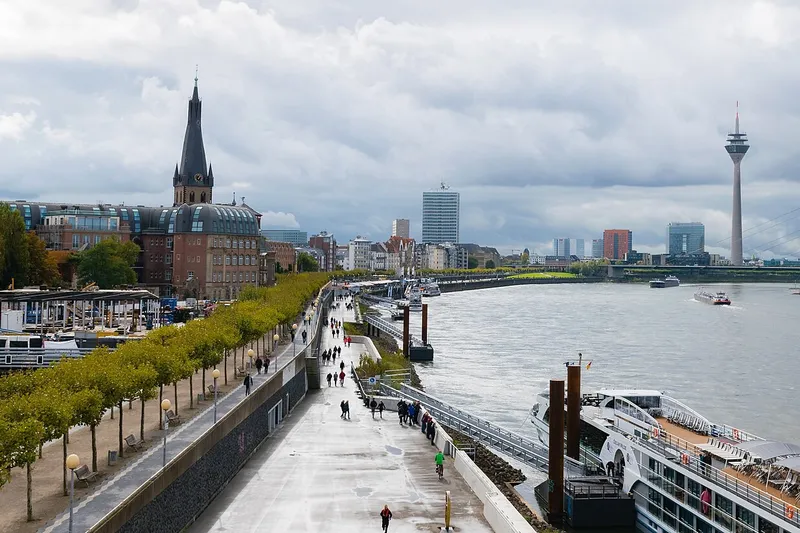 River cruise ship docked along an urban riverfront