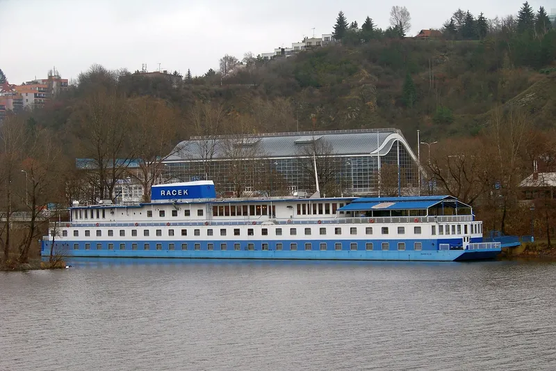 Blue-and-white Racek botel permanently moored on Prague’s Vltava River