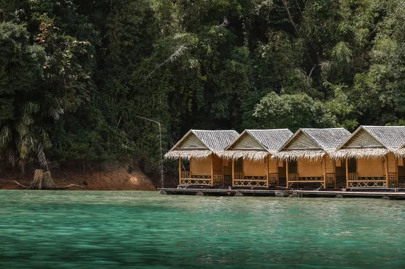 Floating eco-lodge cabins moored on a forest lake