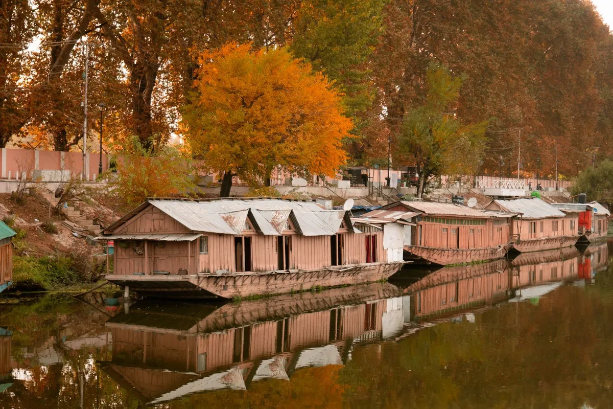 Traditional wooden WelcomHeritage Gurkha houseboats moored on Nigeen Lake
